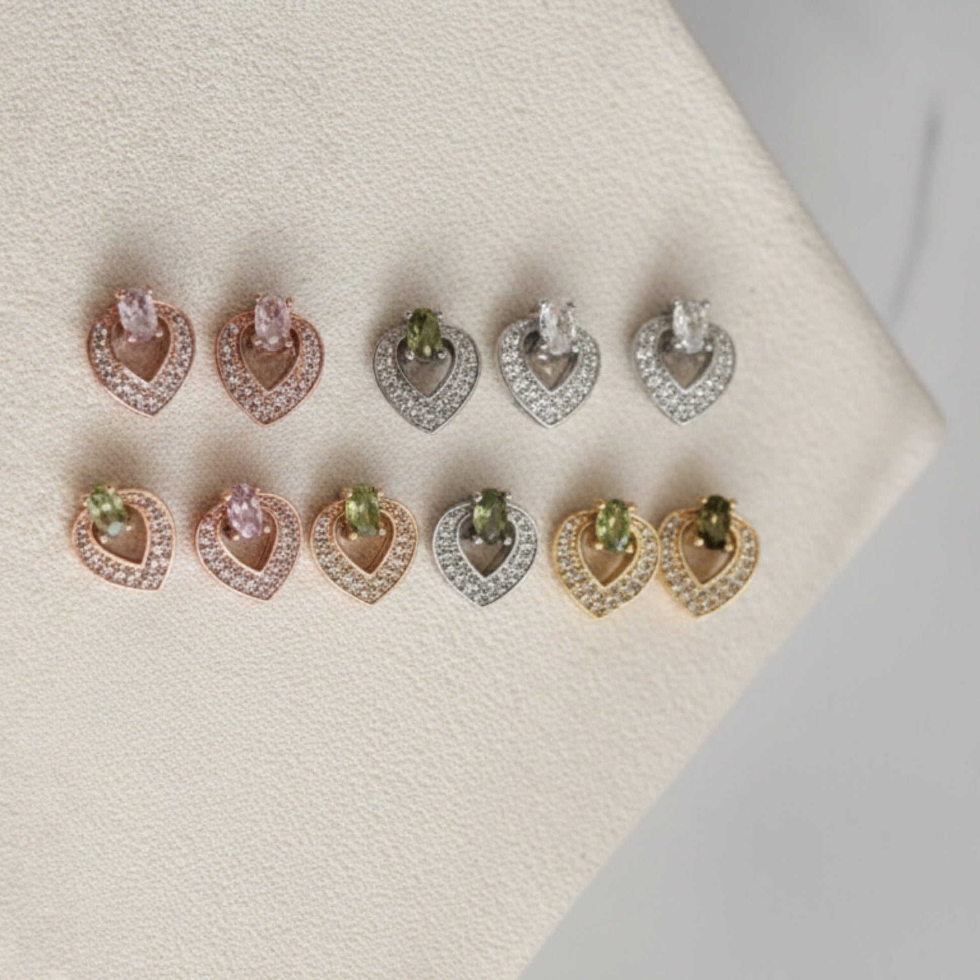 Pair of earrings with gemstones on a textured surface